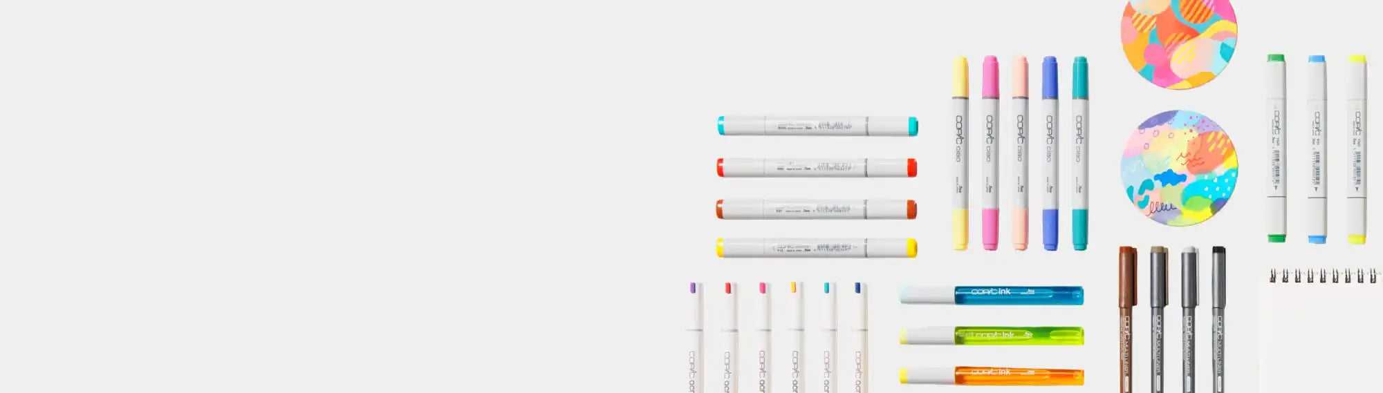 A collection of colorful art markers and pens.