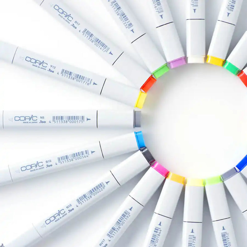 A set of colorful Copic markers arranged in a circle.