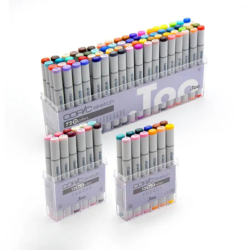 A large set of Copic Sketch markers in various colors, organized in clear cases.