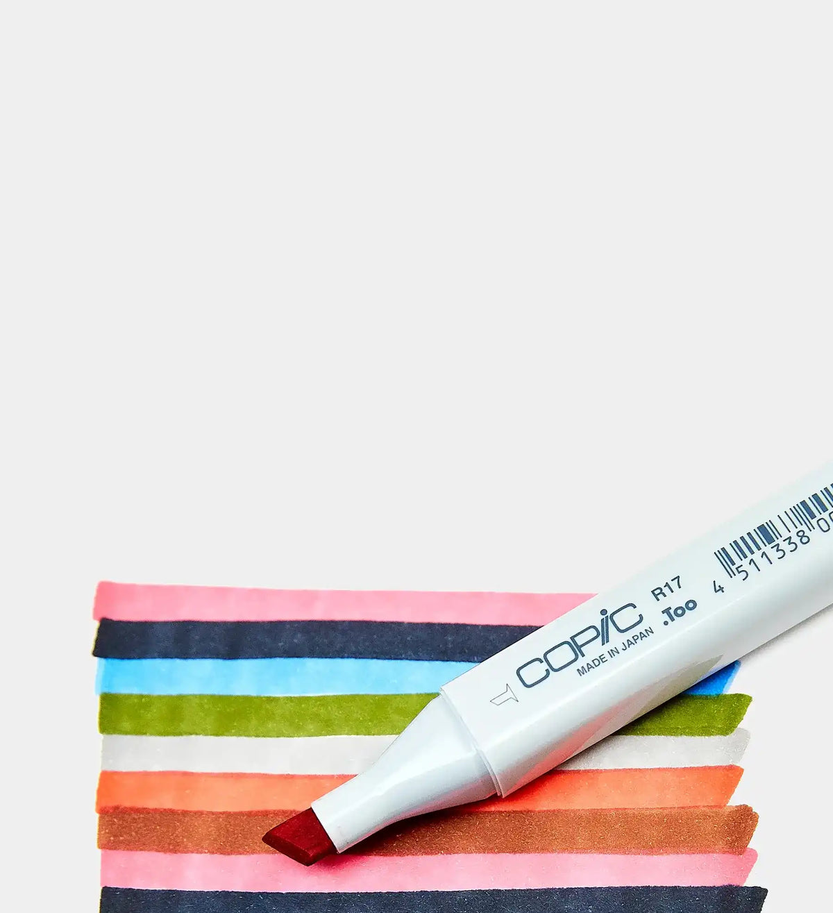 White-barreled Copic R17 marker with a red chisel nib, creating colorful swatches.