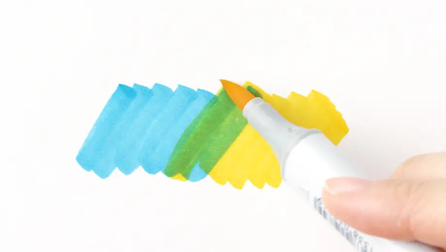 Copic Sketch marker creates new color by layering a blue swatch onto a yellow swatch